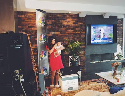 Dierdra holding a baby on the set of CNBC